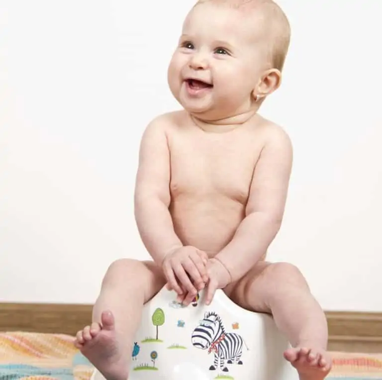Baby using a potty chair