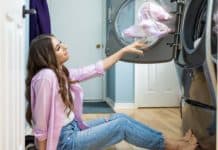 Laundry Routine Made Easy: Best Laundry Products Melissa Maker adding laundry to washing machine