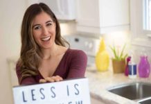 Is it Time to Start Living a Minimalist Life? Melissa holding a sign: Less is the New More
