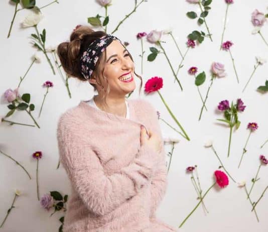 DIY Body Butter Recipe: Natural Skin Care Melissa Maker sitting in front of a wall of flowers