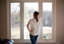 How to Clean Window Sills (Quick, Easy, & Cheap) Melissa Maker standing at window