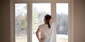 How to Clean Window Sills (Quick, Easy, & Cheap) Melissa Maker standing at window