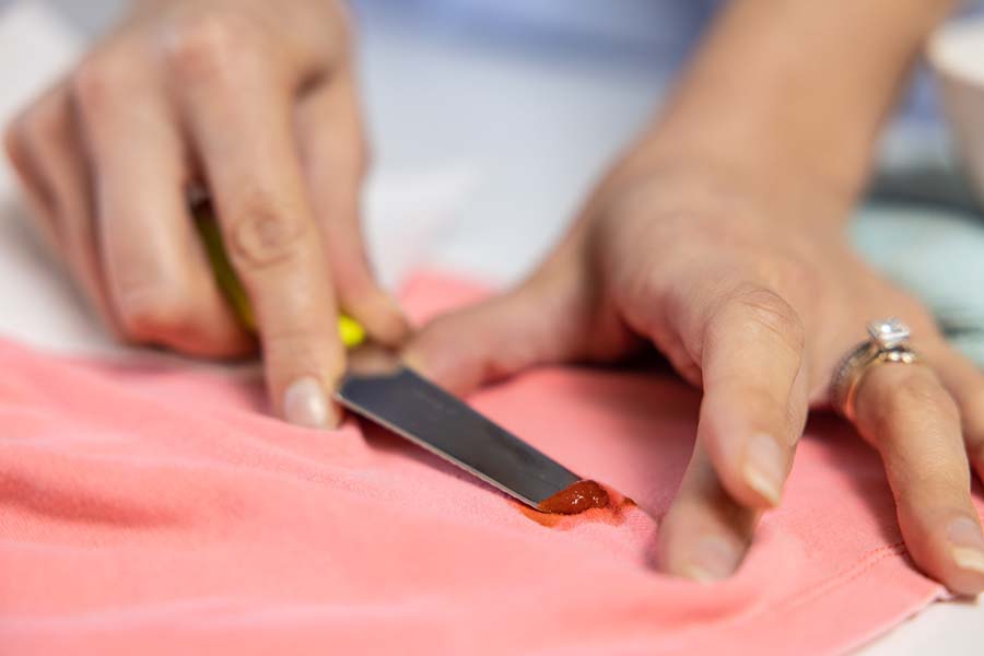 Removing food stain from clothing with knife