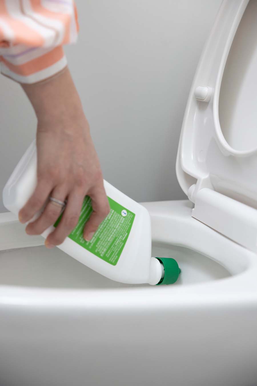 Putting cleaning product in toilet