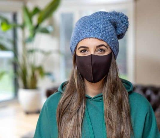 How to Wash Cloth Face Masks: Laundry Tips Melissa Maker wearing a mask and hat