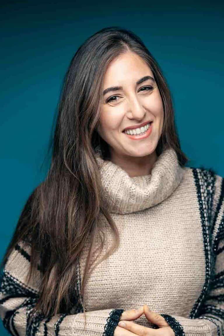 Melissa Maker smiling in front of blue background