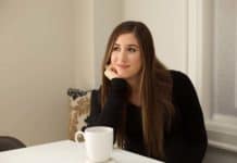 Cleaning A Keurig Coffee Maker Melissa with cup of coffee