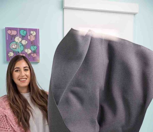 What Is Laundry Stripping?: TikTok Cleaning Hacks Melissa holding a large towel