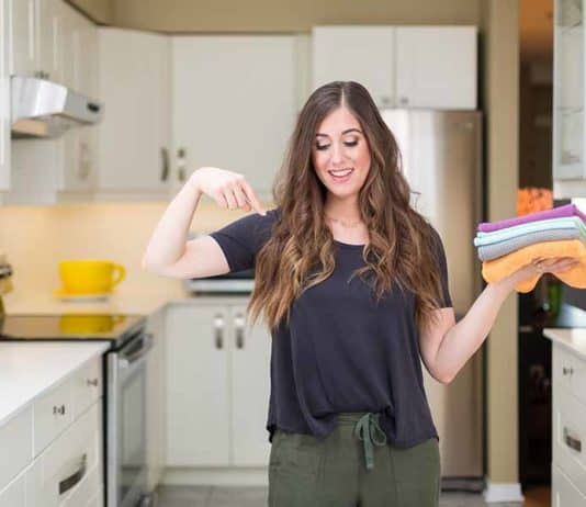 How to Clean Crocs: Shoe Cleaning Tips Melissa holding microfiber cloths in the kitchen