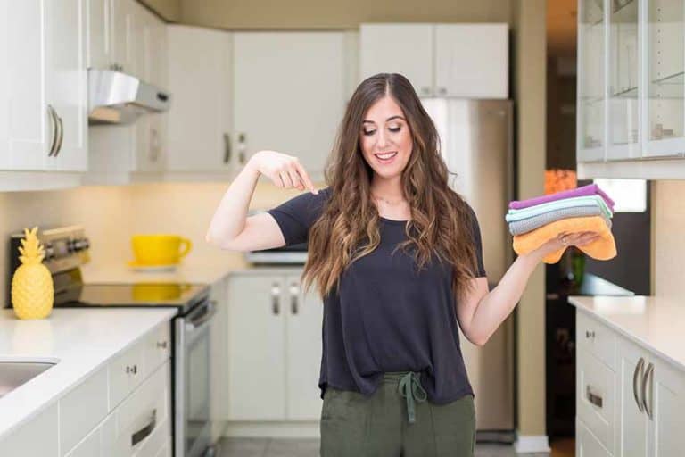 Melissa holding microfiber cloths in the kitchen