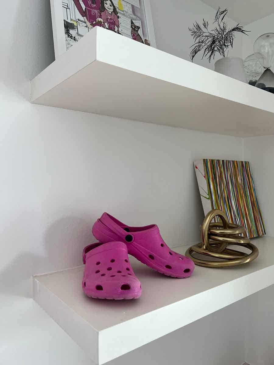 Photo of pink Crocs on a shelf