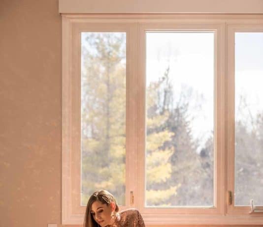 How to Clean Hardwood Floors Without Streaks! Melissa in a dress cleaning the floor