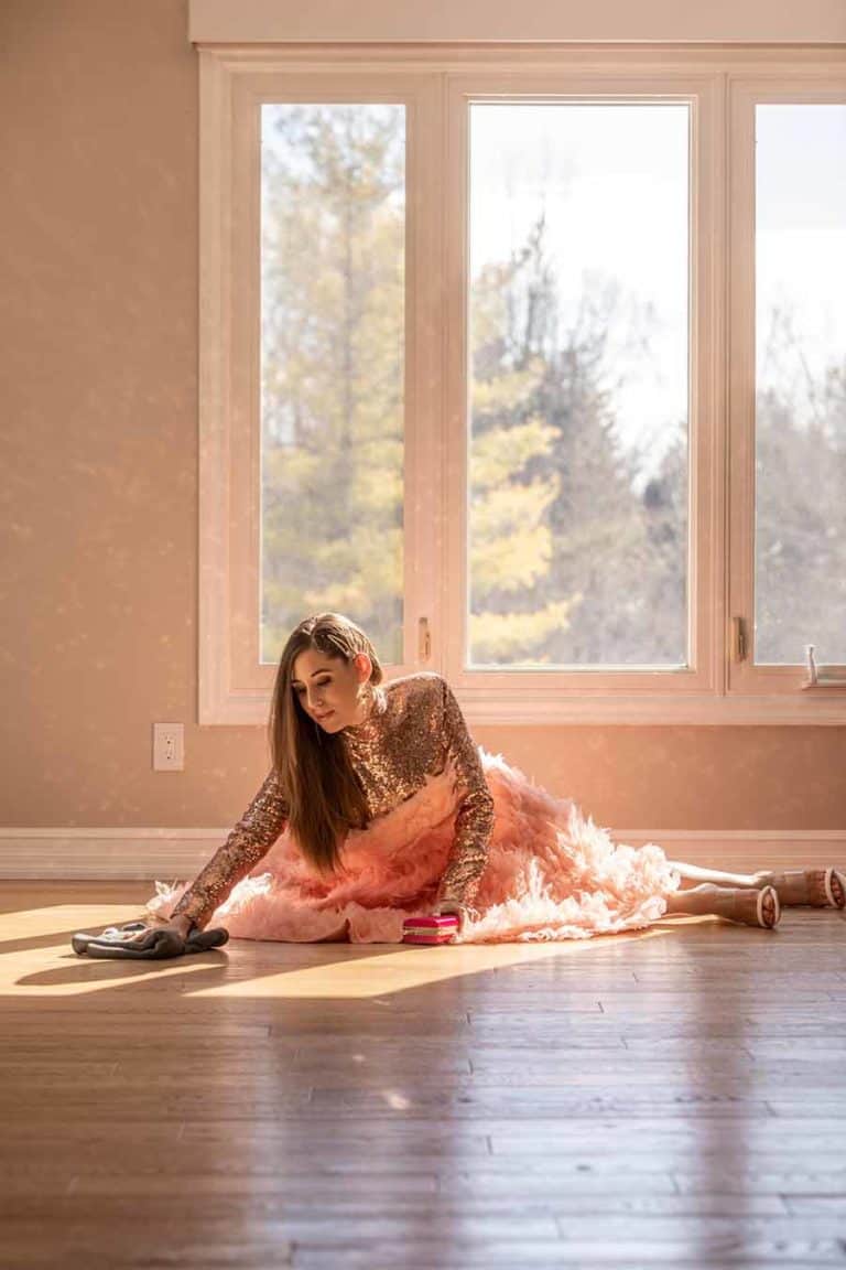 Melissa in a dress cleaning the floor