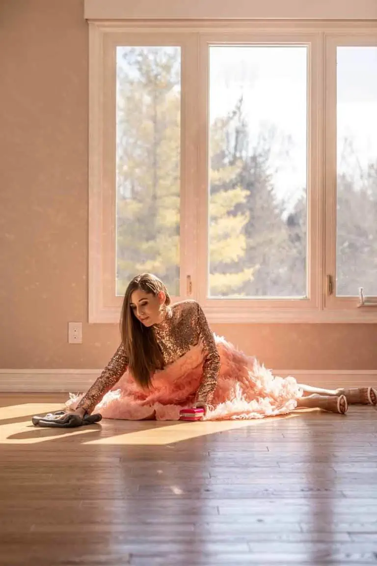 Melissa in a dress cleaning the floor