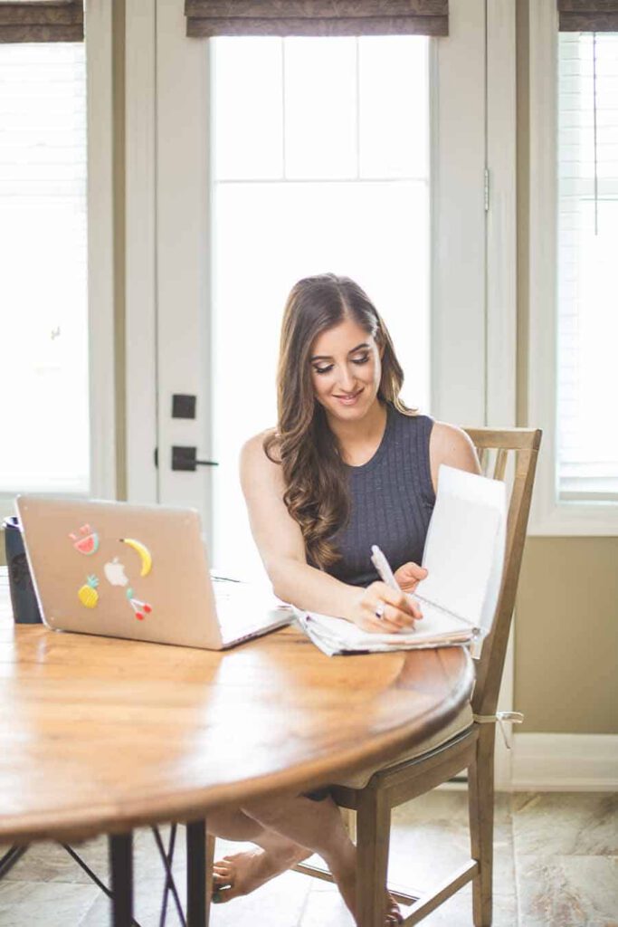 Melissa Maker with laptop and notebook