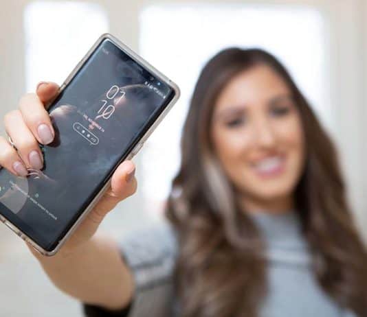 How To Clean A Clear Phone Case Melissa Maker holding a phone