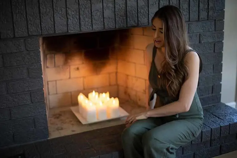 Melissa sitting in front of a brick fireplace