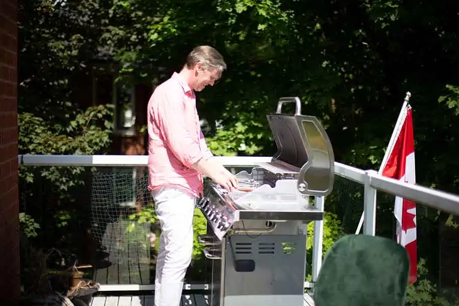 Chad stands at the BBQ