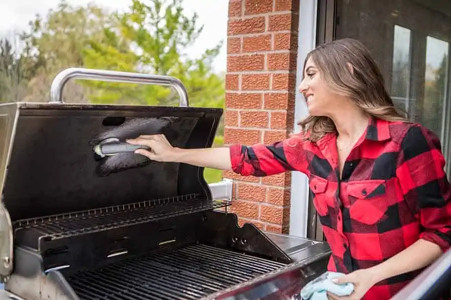 Melissa cleans the barbecue