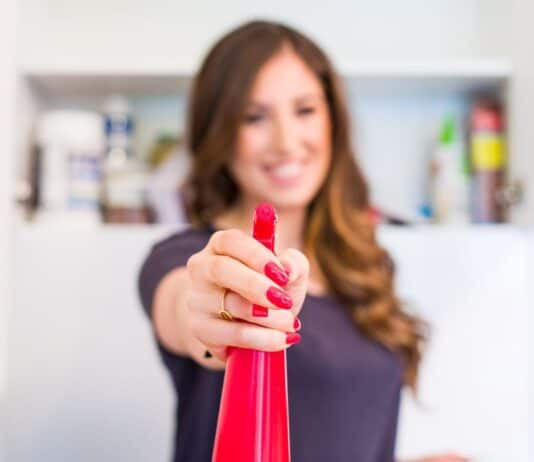 9 Bathroom Cleaning Jobs Melissa with a spray bottle