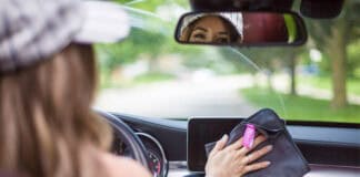 Car Interior Cleaning: The Ultimate Guide melissa maker looking in rear-view mirror